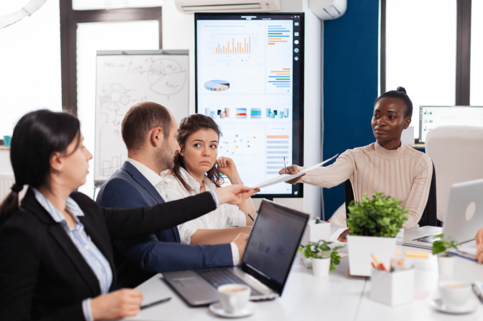 A group of business people sitting around a table.